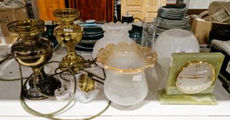 Two gilt metal oil lamps adapted as table lamps, electrified, two Edwardian glass shades, another