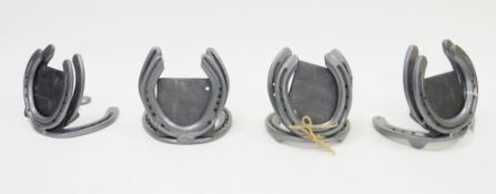 14 place settings constructed from horseshoes, most with slate inserts (14)