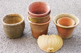 Collection of terracotta plant pots of various sizes and a shell form terracotta wall-mounted