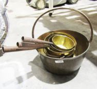 Graduated set of three French-style brass and iron handled saucepans and another similar metal