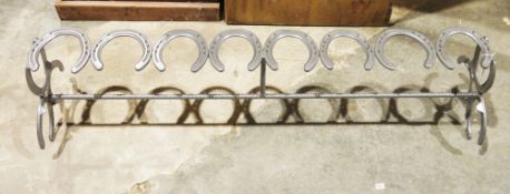 Large boot rack constructed from horseshoes and rebar.