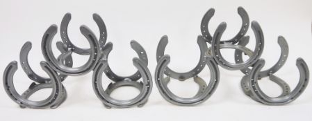 Two pyramid three-bottle wine holders constructed from horseshoes (2)