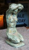 Patinated bronze effect plaster sculpture of a kneeling nude female figure, posed with arms around
