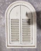 Mirror in white painted shuttered farmhouse-style window frame