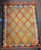 Chobi Kilim orange ground rug with four rows of four lozenges and three rows of three lozenges,
