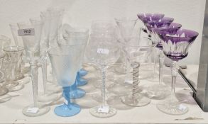 Collection of drinking glasses including a set of four purple overlay stemmed wine glasses, 19.5cm