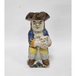English Prattware Toby jug and cover, circa 1820, modelled seated holding a jug of foaming ale