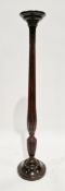 19th century mahogany torchere, the circular top on a turned and fluted baluster support, carved
