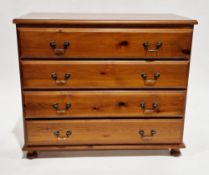 Modern stained pine chest of four long drawers with metal swan neck loop handles, on bun feet,
