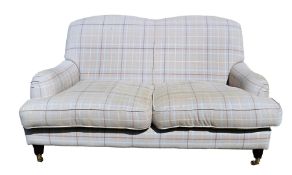 Tartan two-seater settee with shaped back and loose seat cushions, on turned stump supports, brass