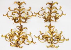 Set of four gilt metal two-branch wall lights in the foliate scrolling rococo style, 34c In that not
