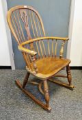 Elm and ash hoop and comb-back elbow rocking chair with pierced splats and crinoline stretcher,