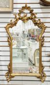LOT WITHDRAWN Giltwood framed mirror in the rococo manner, the moulded frame surmounted by a bird