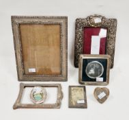 Seven silver photograph frames including a Victorian embossed pierced foliate scrolling frame,