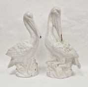 Pair of contemporary white glazed pottery models of pelicans, naturalistically modelled with white