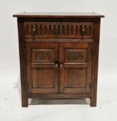 Ercol-style dark elm dresser base comprising a drawer with thumbmould carving over two carved