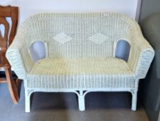 Pale green painted wicker conservatory two-seater settee, 84cm high x 127cm wide x 60cm deep
