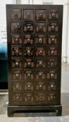 Chinese apothecary's stained wood nest of eight rows of four small drawers, each marked with
