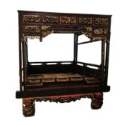 Late 19th / early 20th century Chinese hardwood opium or canopy bed, having a reddish brown and