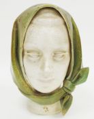 Mid century ceramic bust in the form of a woman wearing a green headscarf with disc-shaped