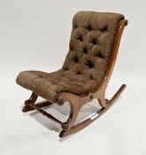19th century mahogany framed rocking slipper chair upholstered in brown buttoned fabric, carved