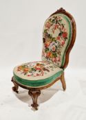 Victorian walnut nursing chair, the balloon back with foliate scroll carved top rail, on a shaped