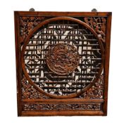 Chinese carved hardwood and pierced screen, wall-mounting, square and centred by carved dragon,