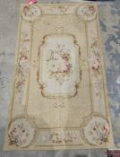 Cream ground rug with central floral medallion, single floral border, 151cm x 81cm