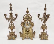Early 20th century French gilt brass three-piece clock garniture, the bell striking clock with roman