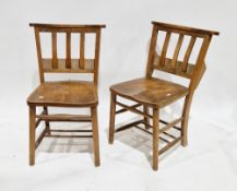 Pair of 19th century beechwood and elm chapel chairs, each with slatbacks having prayer book troughs