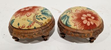 Pair of 19th century Gothic Revival carved walnut circular footstools, the drop in tops with