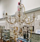 Gilt metal and cut glass six-branch electrolier with prismatic and tear shaped crystal drops and