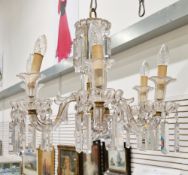 Gilt metal and glass six-branch electrolier, the scrolling branches having double sconces in the