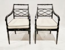 Pair of Regency-style black painted elbow chairs, the frames with cream painted decoration,