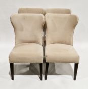 Set of four contemporary dining chairs with chrome-effect studded beige fabric upholstery, each