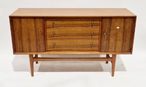 Mid-century Gordon Russell teak sideboard comprising a central bank of three drawers flanked