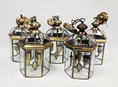 Set of five gilt metal hall lanterns of hexagonal form with domed tops and bevelled glass panels,