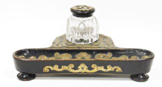 19th century ebonised inkstand with gilt brass strapwork mounts, the cut-glass inkwell fitted on a