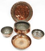 Four Middle Eastern Omani coppered bowls with engraved decoration, largest diameter 24cm together