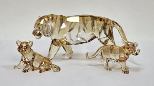Three Swarovski crystal glass tigers including tiger 1003148, companion tiger cub sitting 1016678