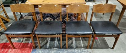 Set of four mid-century Scandinavian inspired dining room chairs with shaped solid backs and black