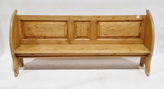Late 19th/early 20th century pine pew-type bench with three panel back and curved ends, on arched