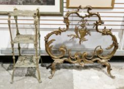 Brass firescreen in the rococo manner, of shaped foliate scrolling outline with a mesh interior,