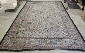 Rust-orange ground carpet with geometric pattern hooked lozenge trelliswork, multipole floral