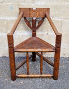 19th century oak turner's corner chair with carved back rail, bobbin carved arms, solid seat, on