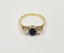 18ct yellow gold sapphire and diamond ring, comprising a central claw-set oval mixed cut sapphire