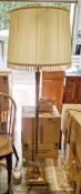 Brass standard lamp, the turned and reeded column on a square base with beaded edge, with shade,