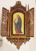 19th century wood and porcelain icon, the gothic walnut pierced carved frame having two doors