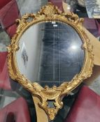 20th century gilt framed oval wall mirror, scrolling acanthus and shell border, approximately