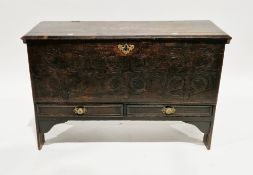 17th century oak plank coffer, the hinged lid opening to a candle box, the carved front panel over